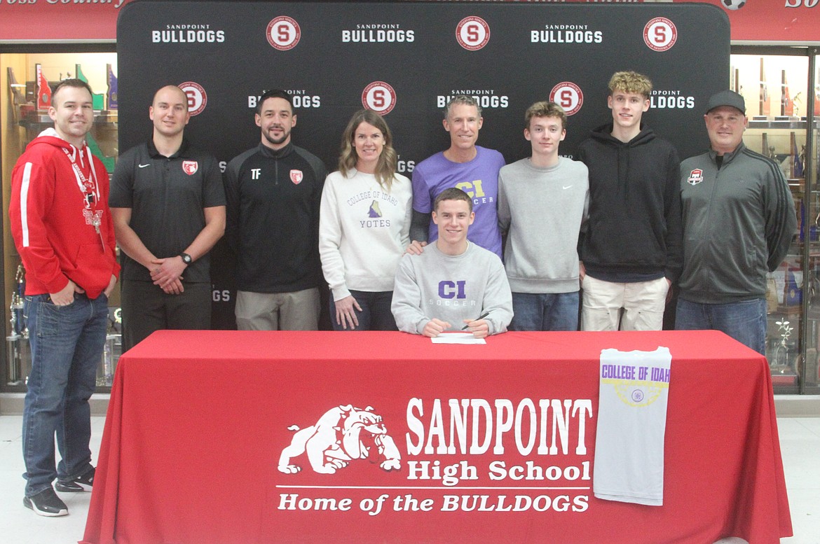 Sandpoint High senior Jett Longanecker signed his letter of intent to play soccer at the College of Idaho on Friday. From left, Sandpoint High associate administrator Chris Taylor, new Sandpoint high head coach Dan Anderson, former Sandpoint High head coach Tanner French, Amy Longanecker, Jett Longanecker, Jameson Longanecker, Pax Longanecker, Kai Longanecker, and Timbers North FC head coach Mike Thompson.