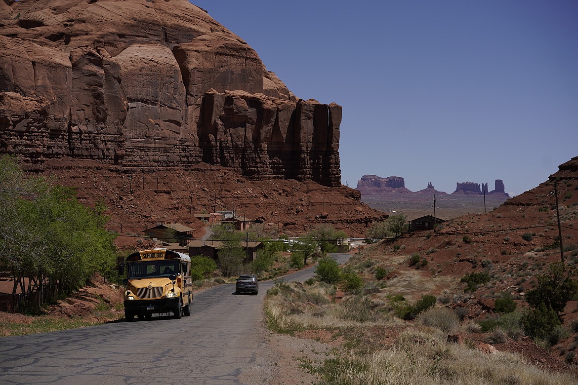 A school bus moves up Rock Door Canyon Rd., in Oljato-Monument Valley, Utah, on the Navajo reservation, April 27, 2020. The U.S. Federal Energy Regulatory Commission has rejected several proposed hydropower projects on the largest Native American reservation in the U.S. The commission has also created a policy that essentially gives tribes veto power over such projects early on. (AP Photo/Carolyn Kaster, File)