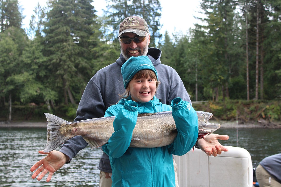 Youth Outdoors Unlimited, a nonprofit that helps young people with disabilities enjoy the great outdoors will host its annual benefit auction in March. Here, Macey Bodily, front, shows off her catch from a Youth Outdoors Unlimited fishing trip, which she caught with the help of Marc Bush, back, owner of Twisted Waters guide service.