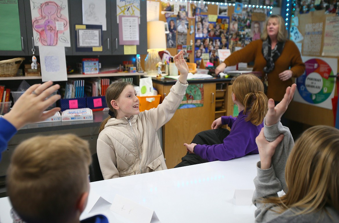 Sorensen Magnet School of the Arts and Humanities fifth grader Finley Taylor and her peers raise their hands to weigh in on a discussion Thursday evening during a meeting of the Coeur d'Alene School District's Student Advisory Group's elementary representatives.