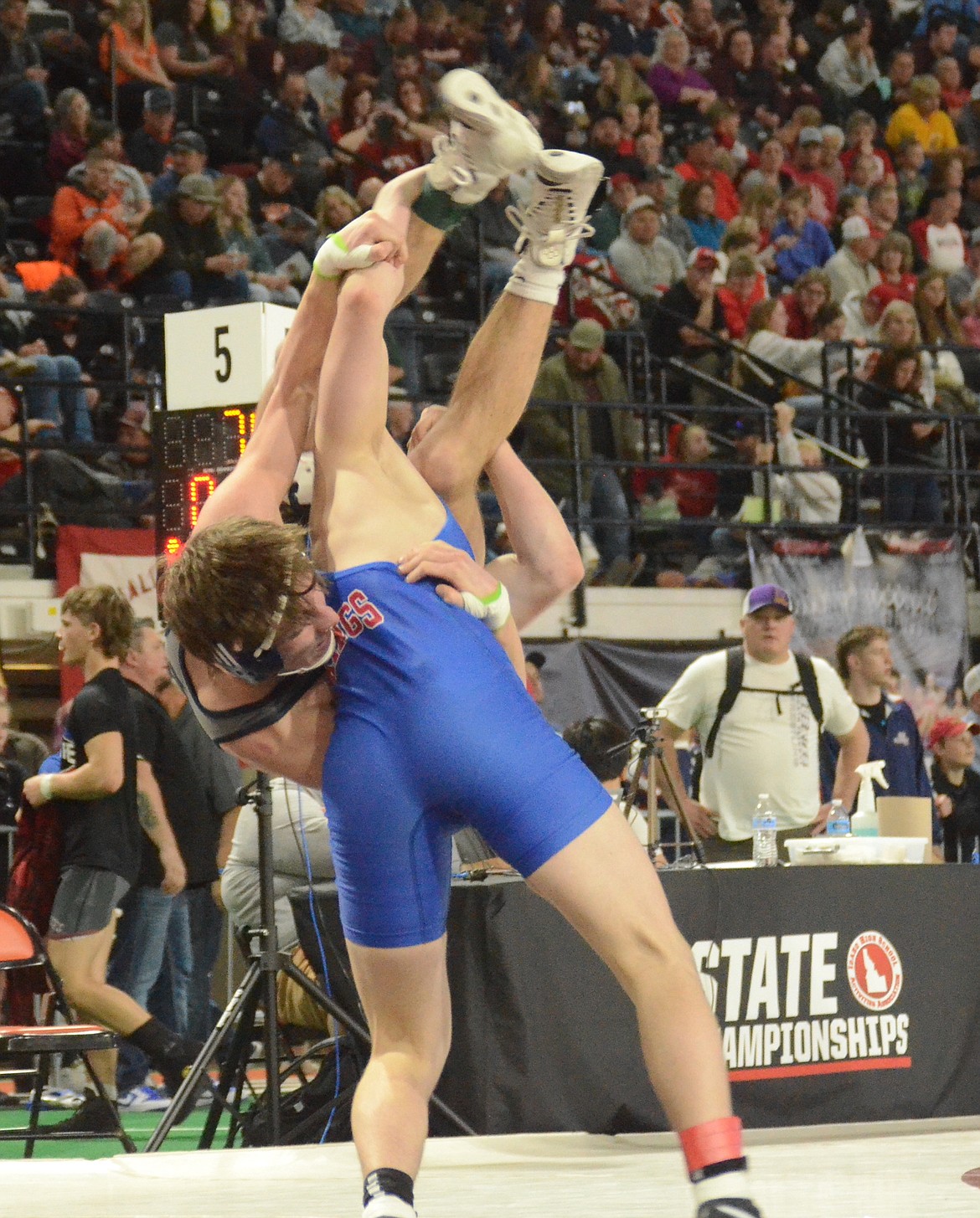 Photo by NORM SEE
Coeur d'Alene junior Colton Tucker takes Lake City junior Alden Curto to the mat during their 5A 145-pound first-round match at the state wrestling championships Friday at the ICCU Dome in Pocatello. Tucker won 5-4, then won his quarterfinal match to advance to today's semifinals.