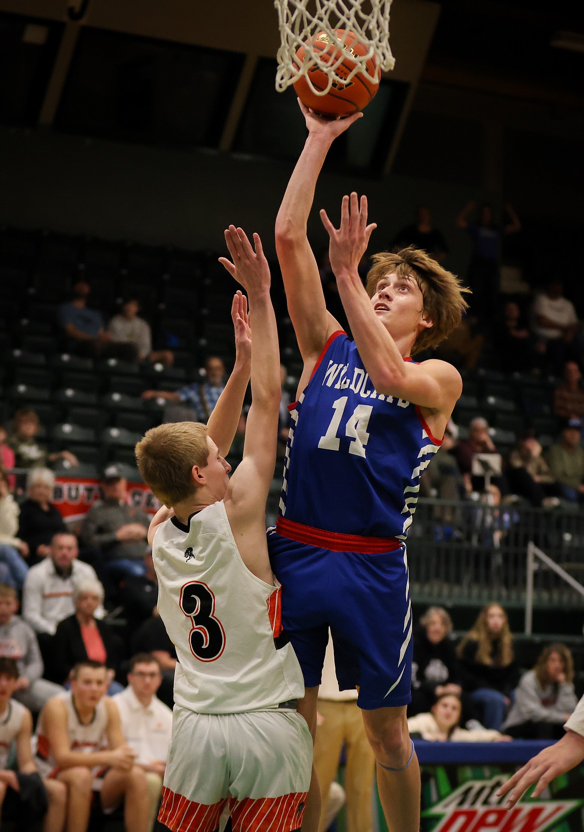 COLUMBIA FALLS guard Jace Hlll (14) goes up for two against Frenchtown Saturday morning at the Western A Divisional. Hill had 33 points in the Wildcats’ 77-47 win, which earned them a berth into state. (Jeremy Weber/Bigfork Eagle)