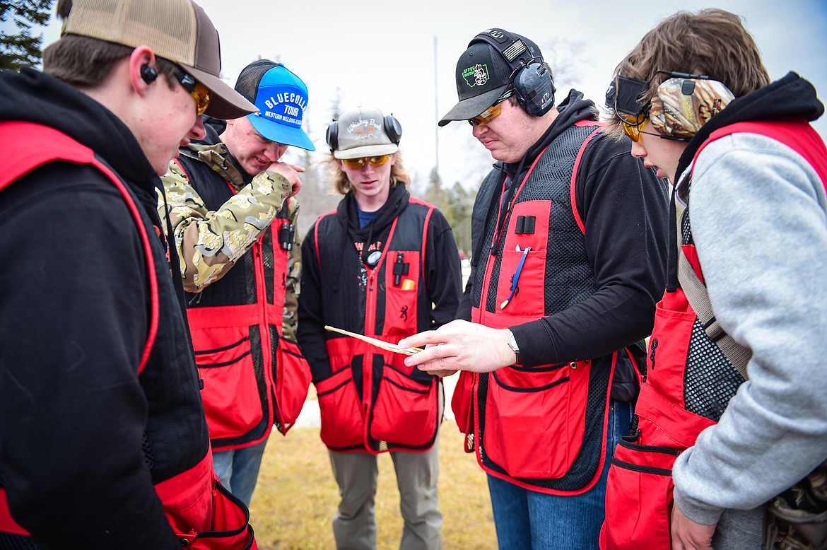 The Wad Squad, from left, Nick DePoe, Quincy Styles, Michael Marrinan, Clint Liem and Chase DePoe look over their scores after a round of doubles in the Pheasants Forever Youth Shooting League at the Flathead Valley Target Club on Saturday, Feb. 24. (Casey Kreider/Daily Inter Lake)