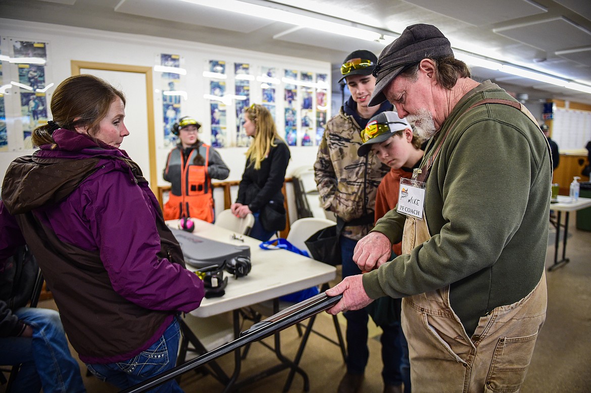 Mike Kiel, a coach with the Pheasants Forever Youth Shooting League, gives a few pointers before a round at the Flathead Valley Target Club on Saturday, Feb. 24. (Casey Kreider/Daily Inter Lake)