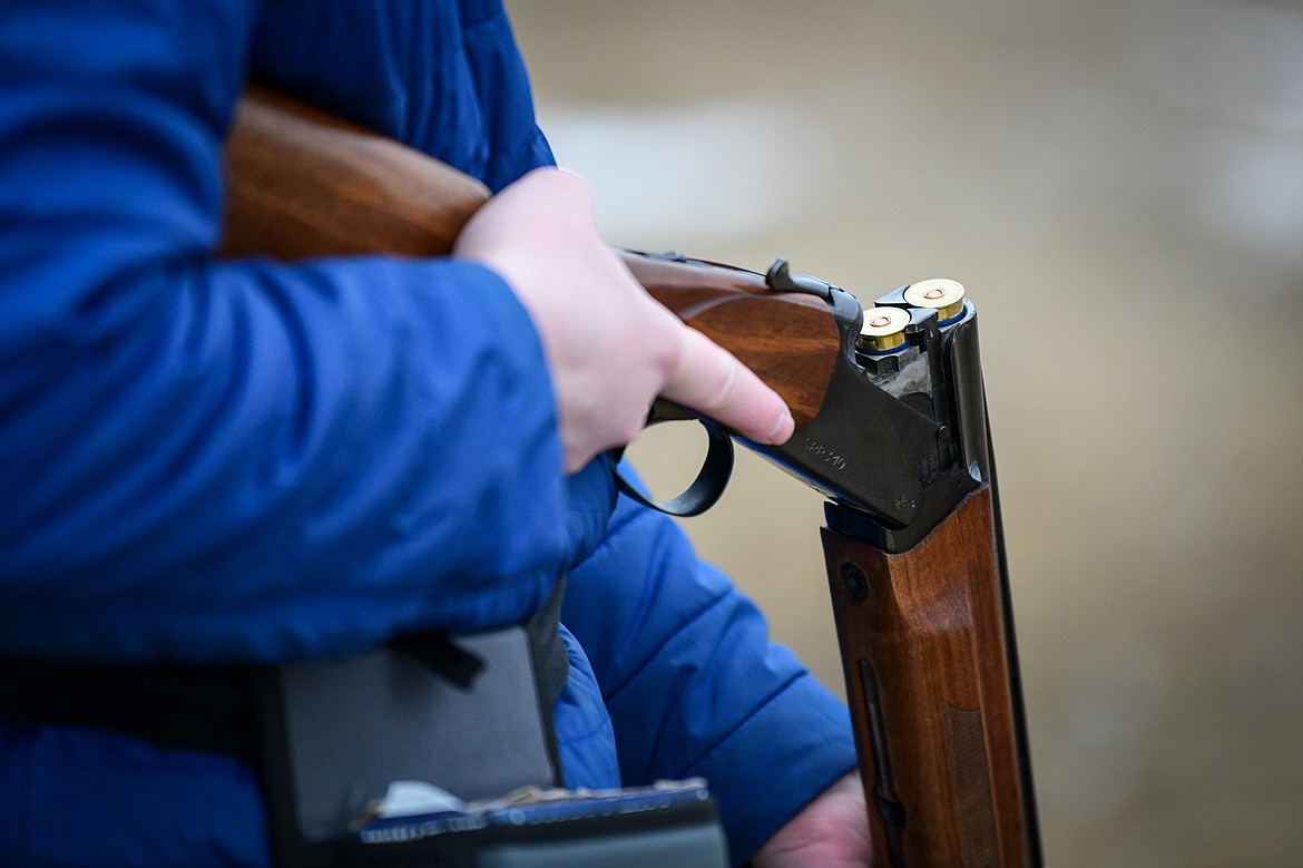 Grayson Calles, with the Wing Nuts, loads his shotgun before a round of doubles  in the Pheasants Forever Youth Shooting League at the Flathead Valley Target Club on Saturday, Feb. 24. (Casey Kreider/Daily Inter Lake)