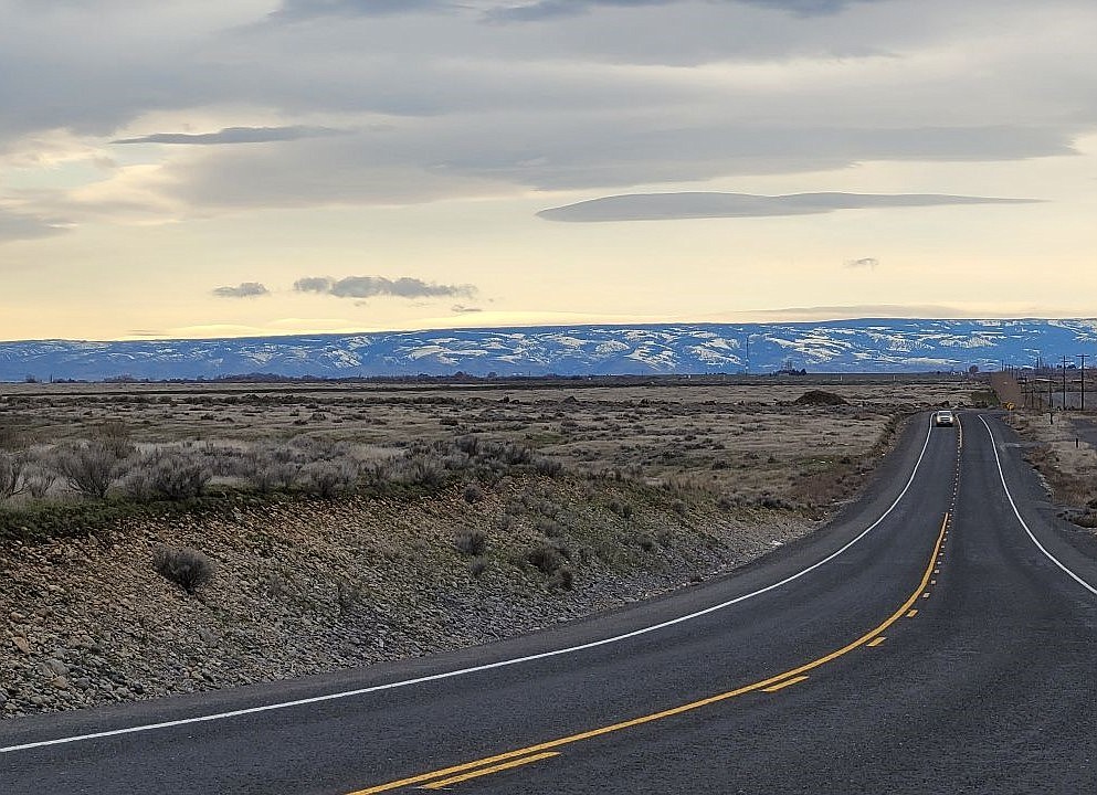 A car travels south on Road 12 NW near Ephrata on Saturday with the mountains past Quincy in the background. Last week saw a few sunny days, a much-needed reprieve after months of fog and gloom.