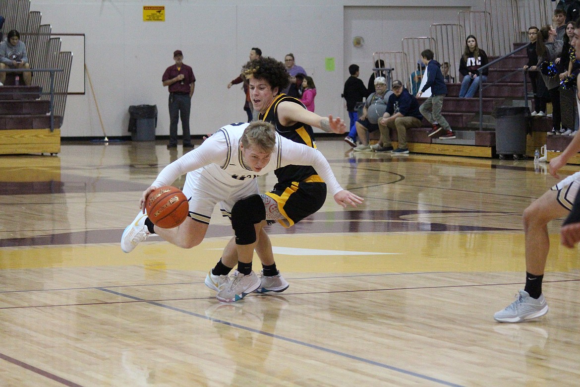 MLCA/CCS point guard Jonah Robertson (34) maneuvers around a Cusick player in the Lions’ 65-54 win Friday.