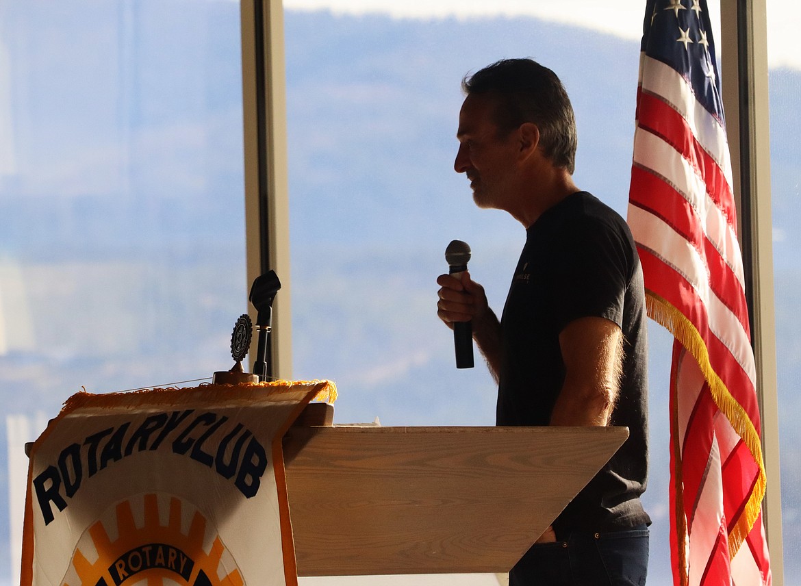 Tom Mueller's silhouette is outlined as he speaks to about 260 people at the Hagadone Event Center on Friday.