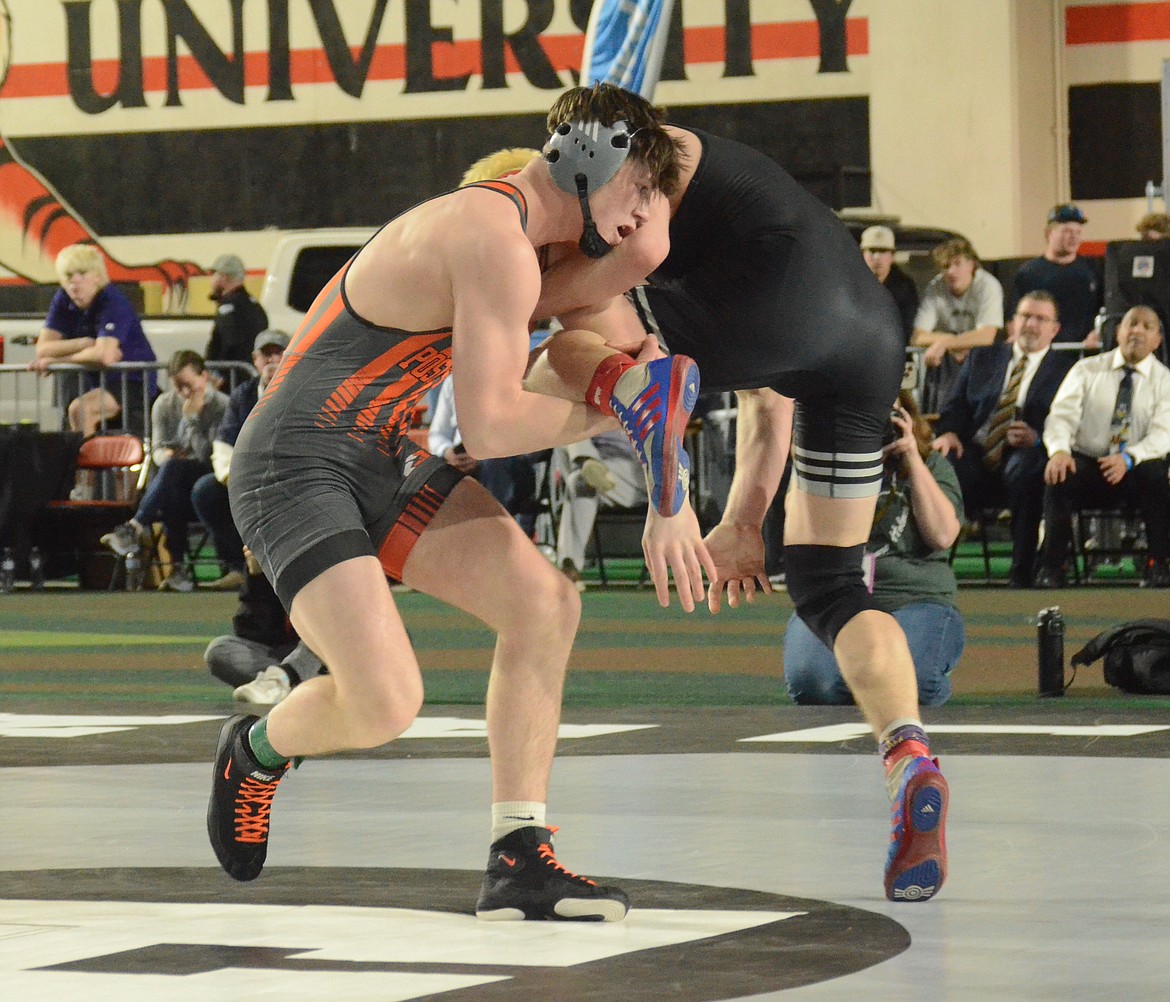 Photos by NORM, DAN and KELLY SEE
Post Falls junior Seth Martin, left, tries to control Jonathan Seamons of Nampa in their 5A 170-pound title match at the state wrestling championships Saturday at the ICCU Dome in Pocatello.