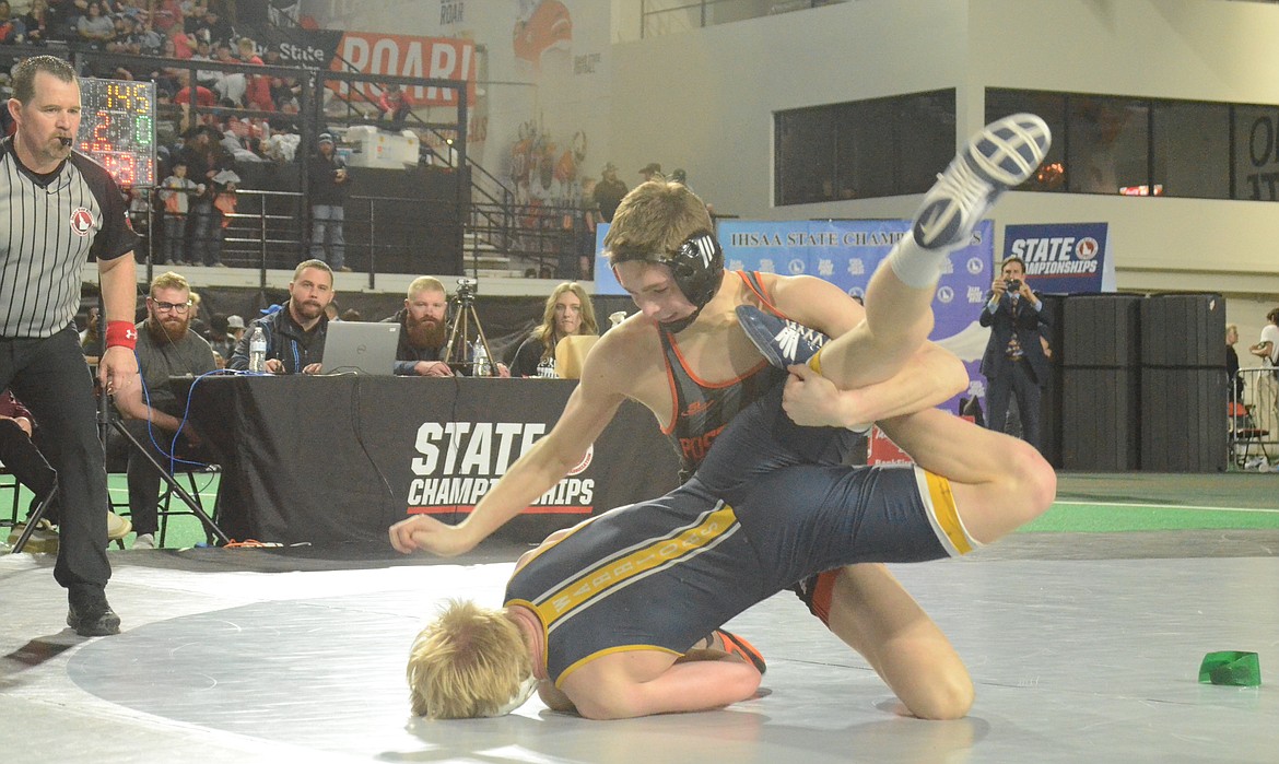 Photos by NORM, DAN and KELLY SEE
Post Falls senior Tyson Barnhart controls Logan Shaver of Meridian in the 5A 145-pound title match at the state wrestling championships Saturday at the ICCU Dome in Pocatello.