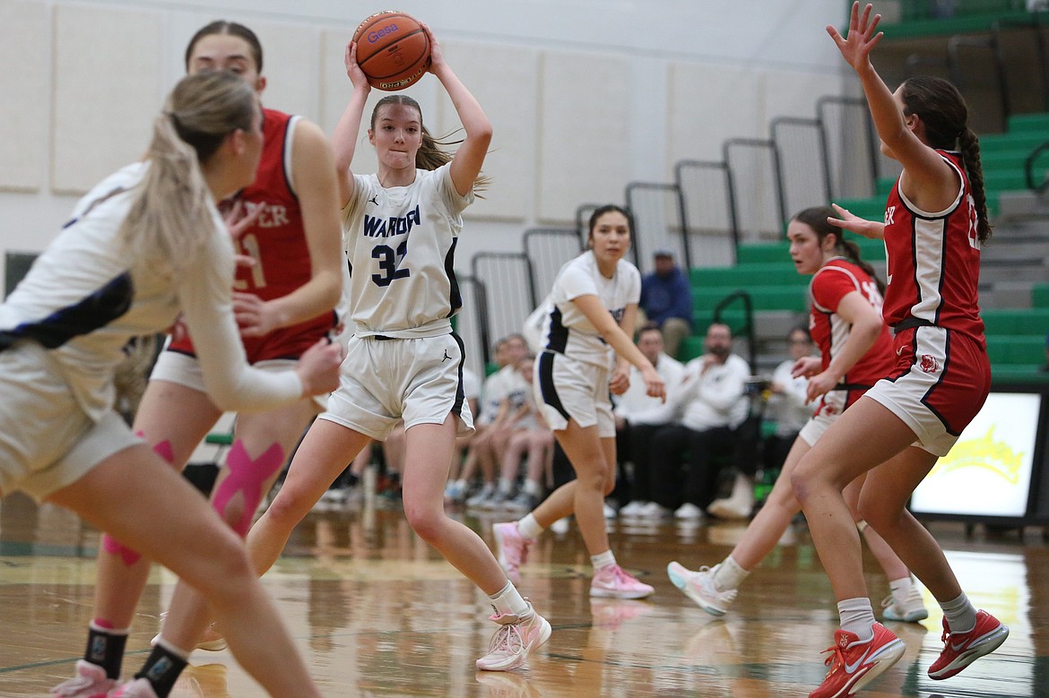 Warden junior Lauren Chamberlain (32) looks for an open teammate in the first half against Brewster.