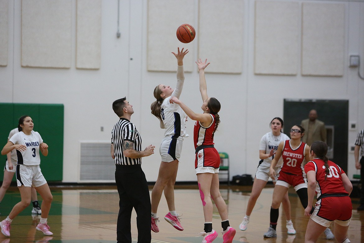 Warden senior Lauryn Madsen (0) jumps up to grab the opening tipoff for Warden.