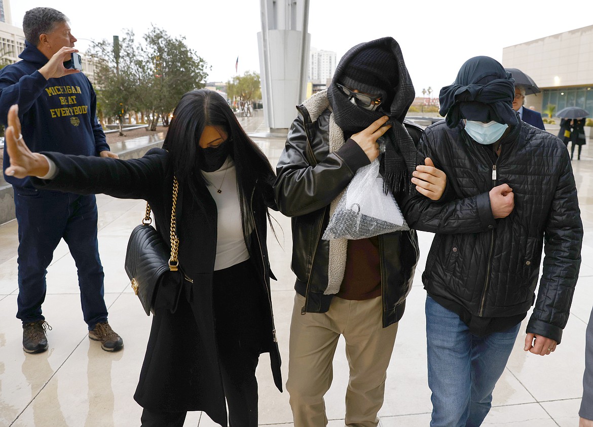 Alexander Smirnov, second from right, leaves the courthouse on Feb. 20, 2024, in Las Vegas. Smirnov, a former FBI informant charged with lying about a multimillion-dollar bribery scheme involving President Joe Biden’s family, will appear in a California federal court on Monday, Feb. 26, as a judge considers whether he must remain behind bars while he awaits trial. Special counsel David Weiss’ office is pressing Judge Otis Wright II to keep Smirnov in jail, arguing the man who claims to have ties to Russian intelligence is likely to flee the country. (Bizuayehu Tesfaye/Las Vegas Review-Journal via AP, File)