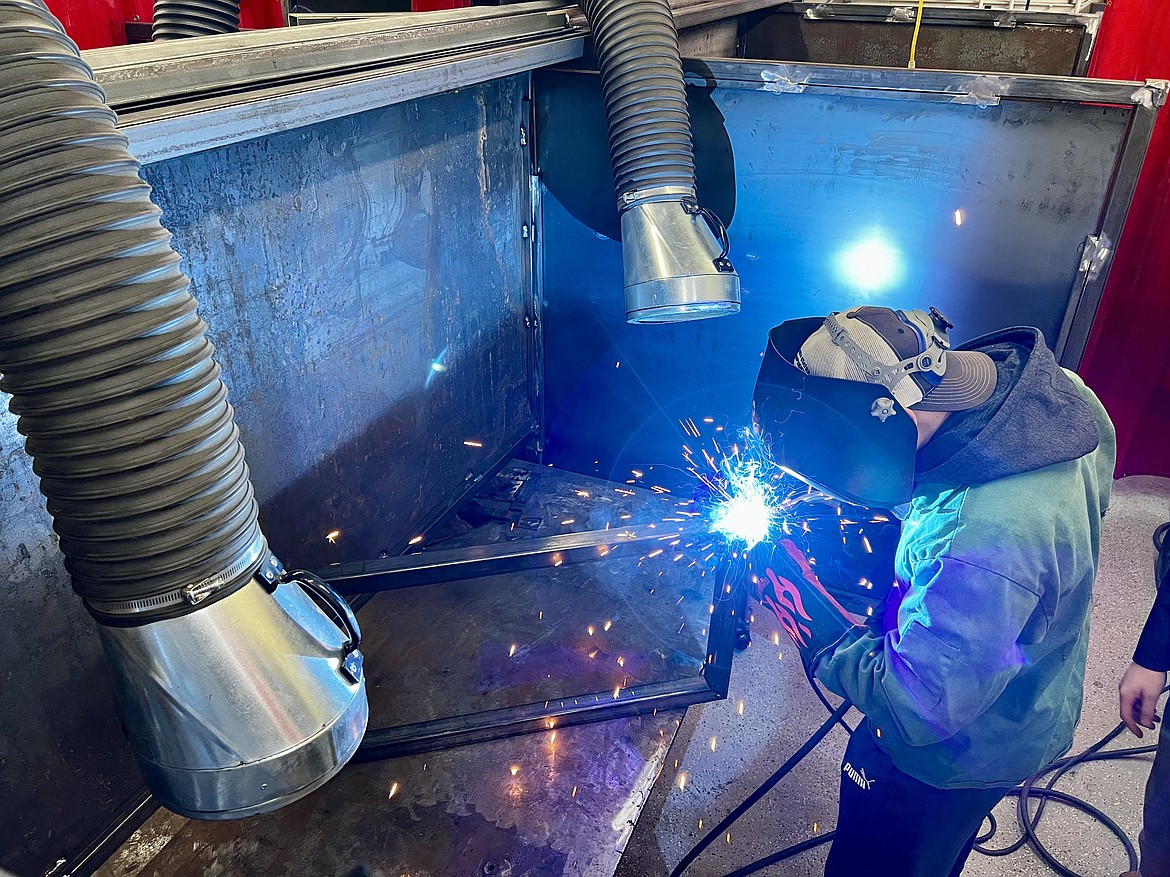 Mullan High School senior Alex Trogden uses a new welder to fabricate a part of the framework for a new tool rack in the school's shop classroom.