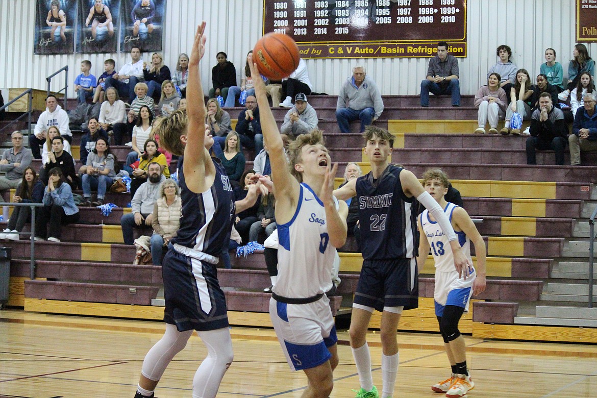 Soap Lake’s Ruvim Goloborodko (0) goes for the layup against Summit in the Eagles’ 78-71 loss in the first round of the WIAA 1B state basketball tournament Friday.