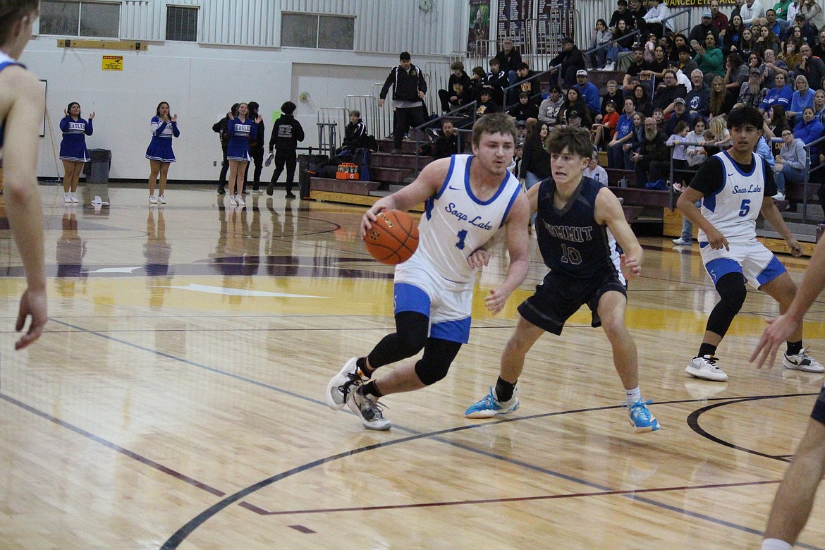 Pavlo Stoyan (1) drives from the top of the key in Soap Lake’s game against Summit.