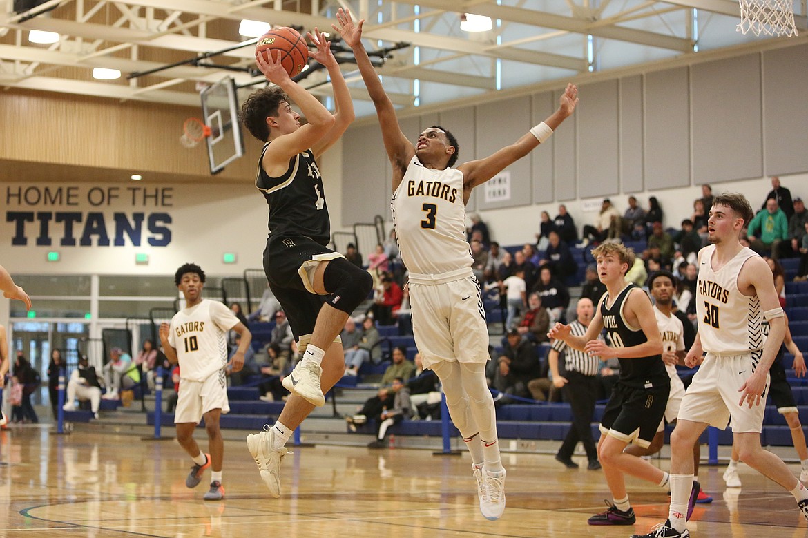 Royal junior Ezra Jenks, in black, shoots the ball in the second half against Annie Wright Saturday.