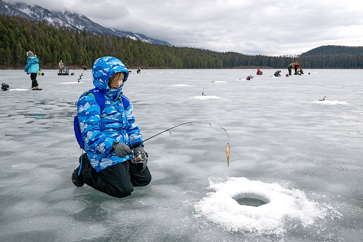 GGES fourth grader Lily Barnett pulls a fish up from Murphy Lake Thursday, Feb. 22. (Avery Howe photo)
