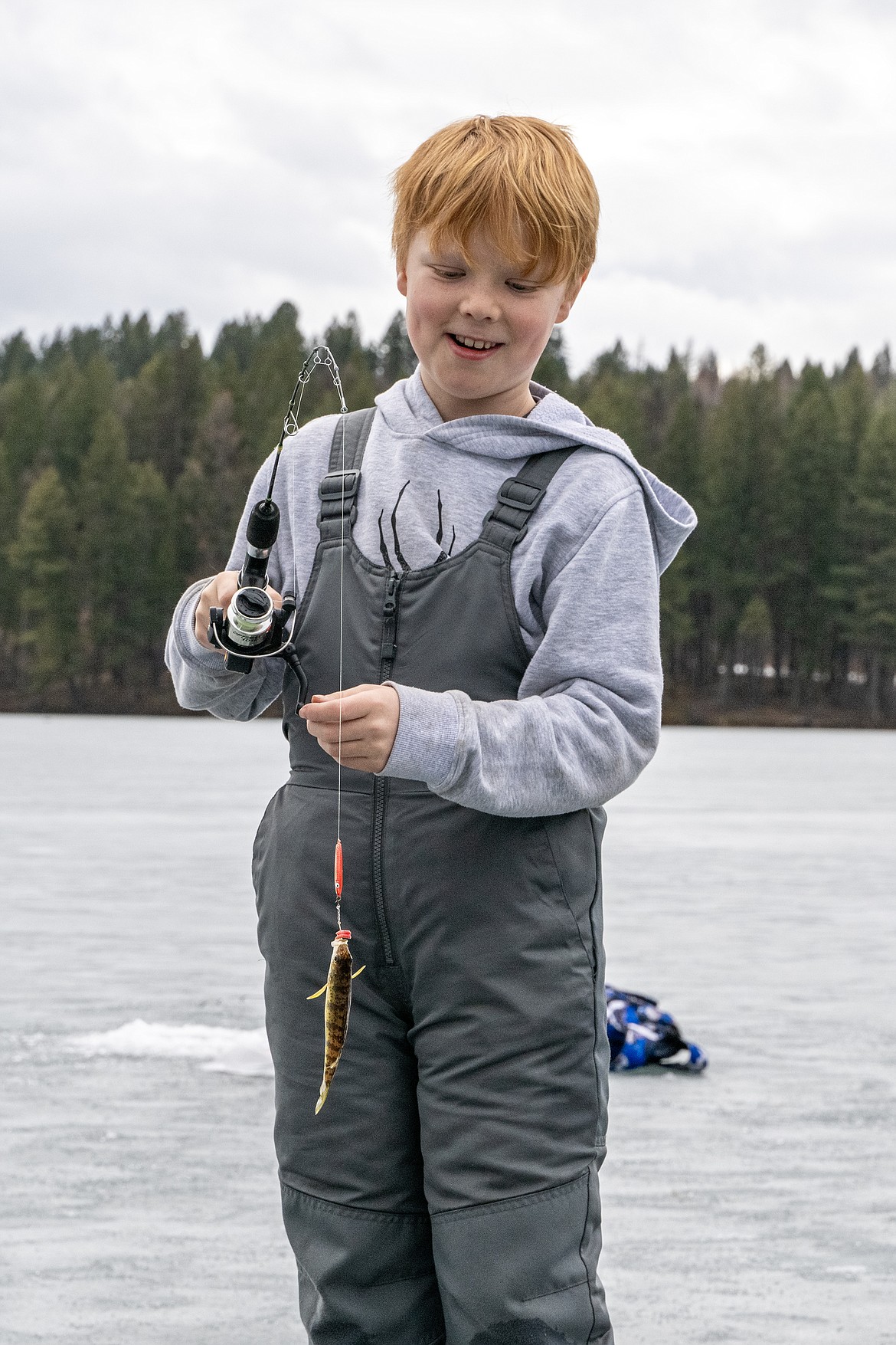 GGES fourth grader Kason Hall catches his first fish on Murphy Lake with FWP’s Hooked on Fishing program Thursday, Feb. 22. (Avery Howe)