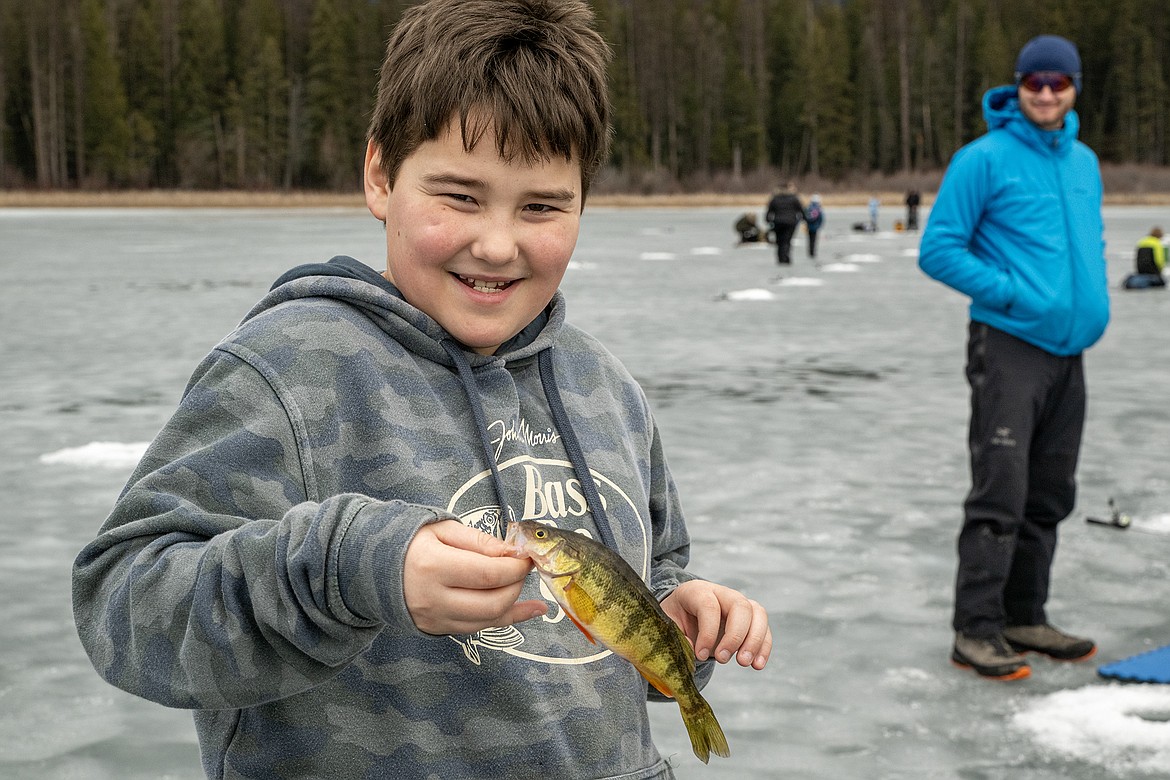 Elias Hilliard shows off his catch — one of the largest of the day — on Murphy Lake Thursday, Feb. 22.