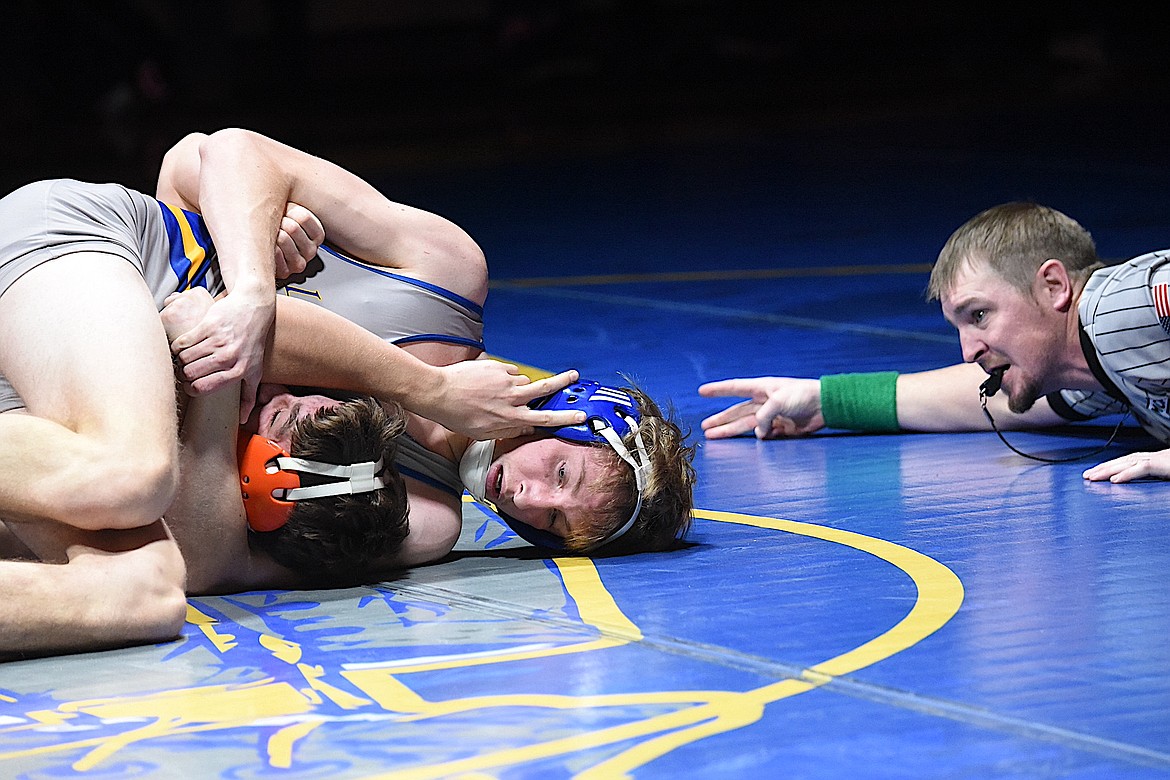Wrestling official JR Rebo awards back points to Libby's Tanner Wolfe during a match in December 2023. Rebo was the last Greenchain wrestler to win three straight state titles before Jace DeShazer did it this season. (Scott Shindledecker/The Western News)