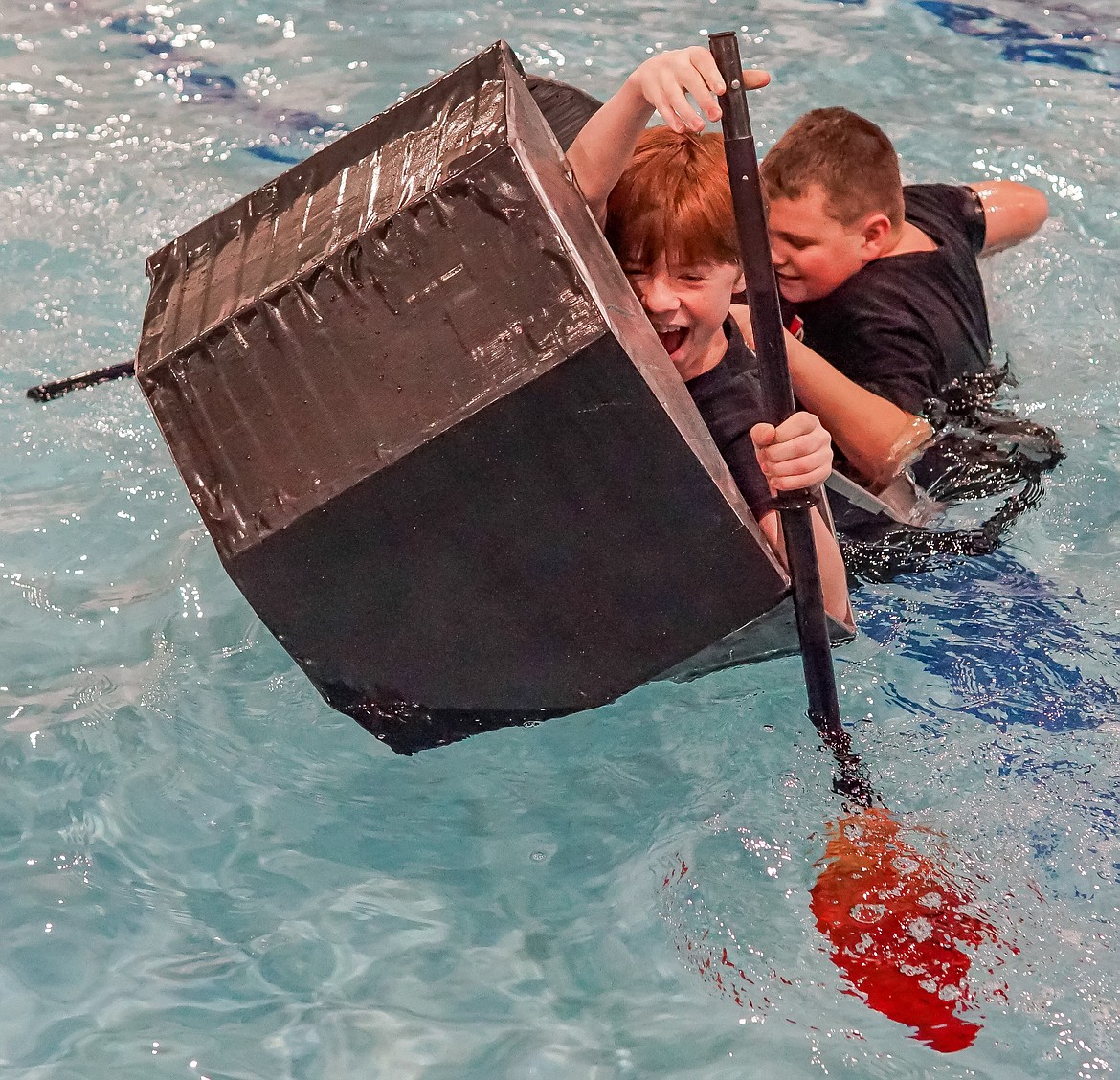 Seventh graders Cooper J Brandt (front) and Noah M Godzien (back) are all smiles, but they didn't quite make it across the pool as their boat sank.