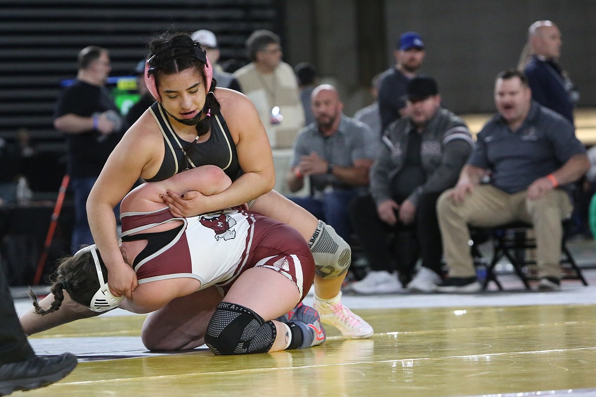 Royal senior Emma Villa, background, wrestles against Montesano’s Kya Roundtree in the 2A/1A/B 170-pound finals at the Mat Classic.