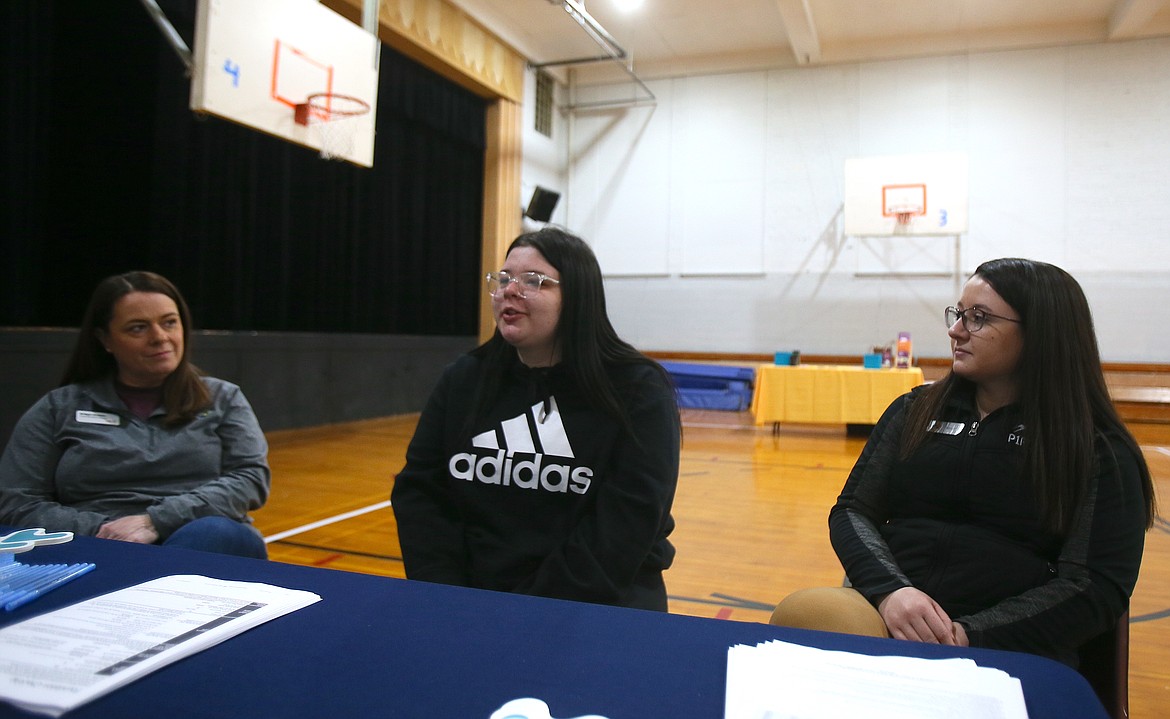 Mountain View Alternative High junior Alliandra Bergen, center, discusses building credit and interest with STCU community bank manager Bridget Goodwin, left, and P1FCU community development specialist Ashley Adams during Mountain View's inaugural Bank Day in the school gym Tuesday morning.