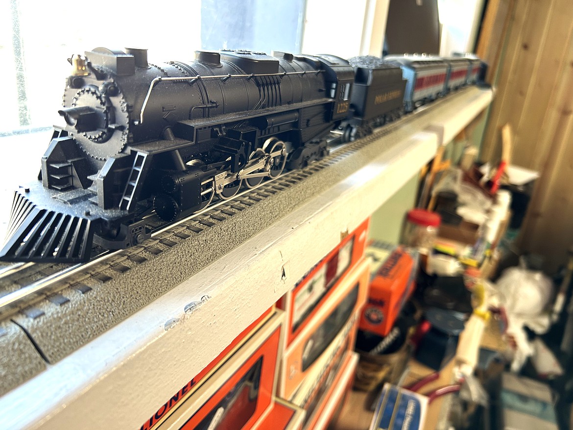 A Lionel train rests on the windowsill of C's Train & Antique Shop.