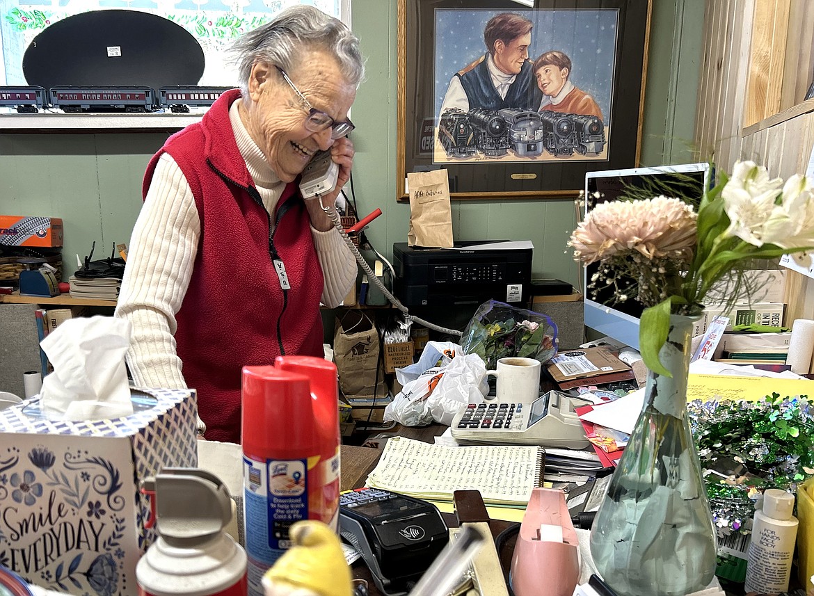 Helen Campilli talks on the phone at C's Train & Antique Shop in Spirit Lake on Tuesday.