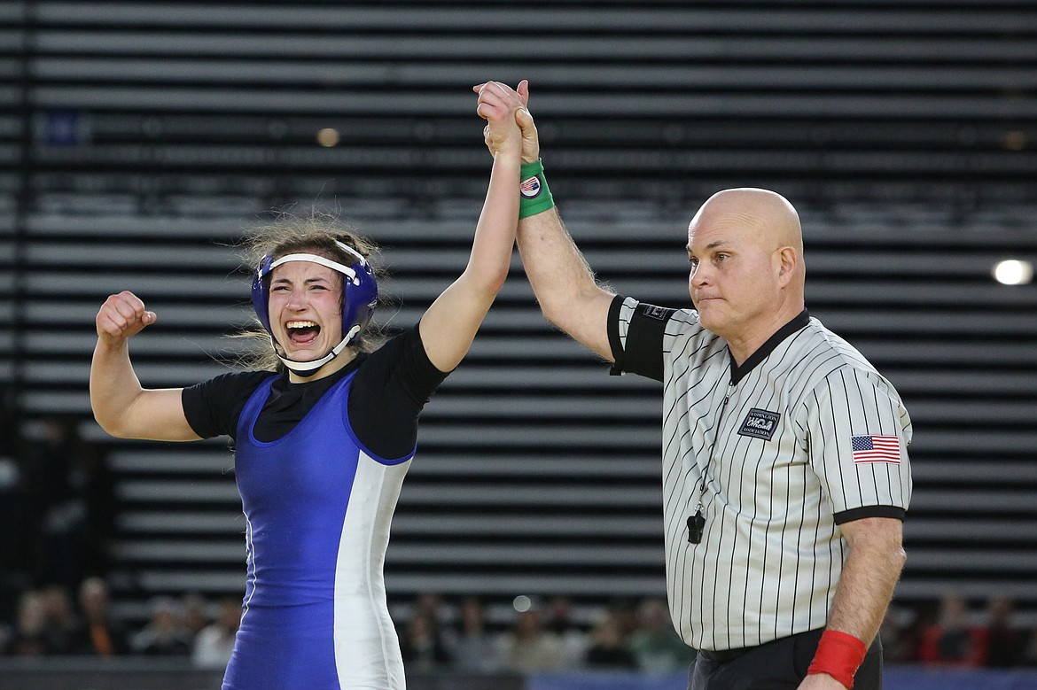 Warden senior Jada Hernandez, left, celebrates after winning a state championship at the Mat Classic.