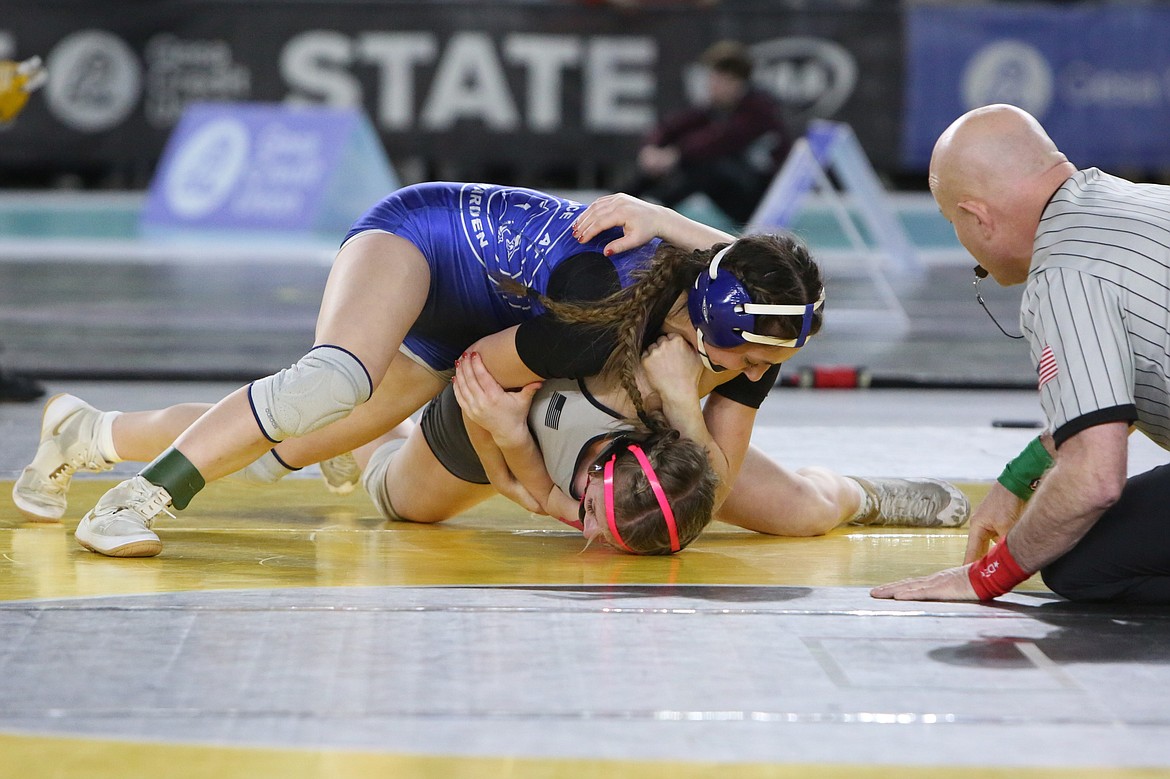 Warden senior Jada Hernandez, top left, wrestles against Orting’s Brooklyn Jones in the 2A/1A/B 120-pound finals.