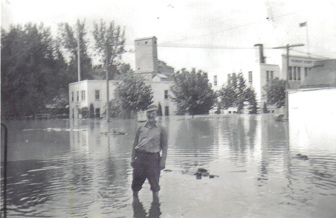 Orval E. Fredericksen is pictured standing in front of the post office during the 1948 flood. The courthouse and sheriff’s office can be seen behind him.