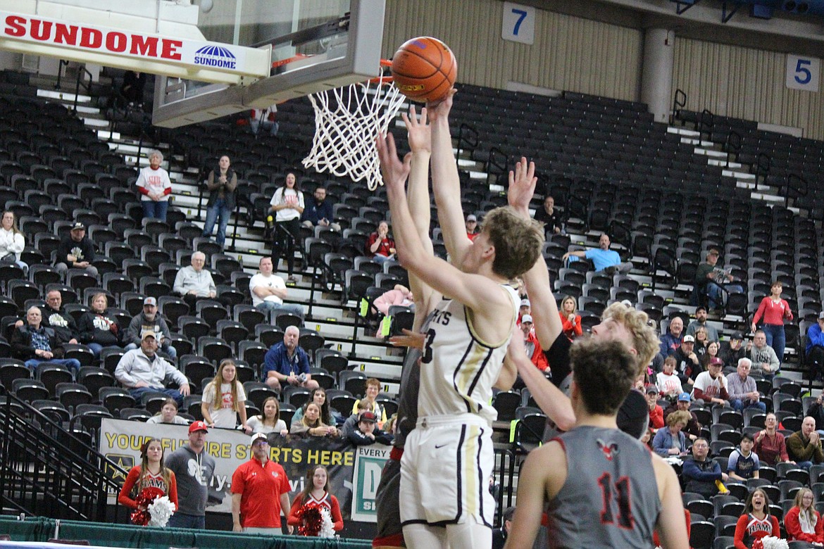 Royal’s Caden Allred, in white, puts up a shot against Riverside in the Knights’ 55-40 loss at the Class 1A state tournament Wednesday.