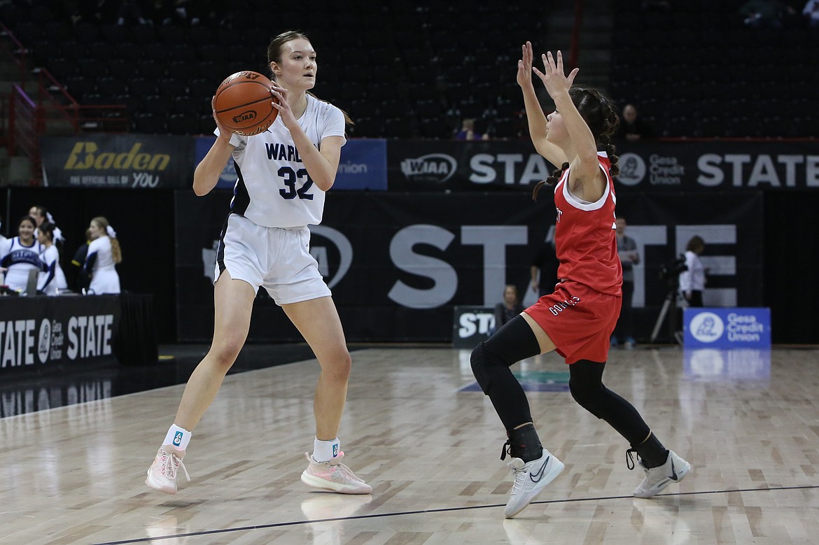 Warden junior Lauren Chamberlain, left, looks for an open teammate against Davenport.