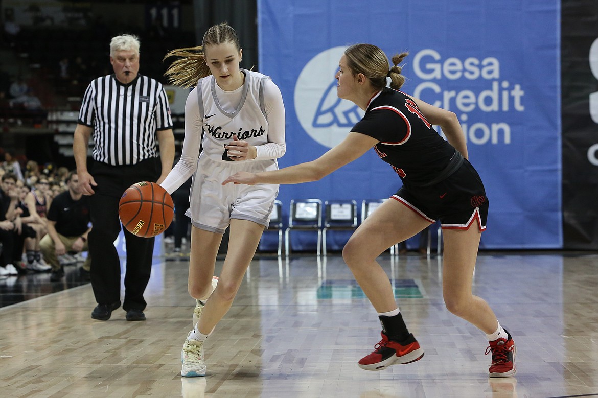 ACH senior Natalie Evers, in white, dribbles the ball down the court in the second half against Garfield-Palouse.