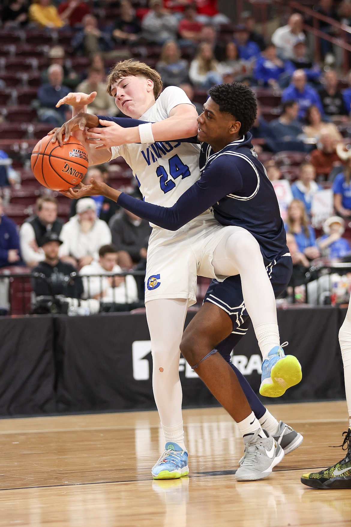 JASON DUCHOW PHOTOGRAPHY
Coeur d'Alene's Caden Symons and Lake City's Josh Watson get tangled up for a loose ball during Thursday's state 5A boys basketball tournament opening round game at the Ford Idaho Center in Nampa.