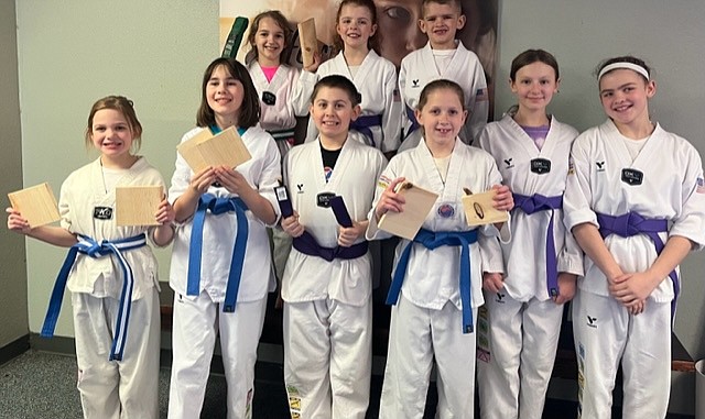 The Sandpoint Martial Arts Intermediate Group. Front row, from left, Mandolin Hinshaw (Blue Stripe Belt), Kate Judd (Blue Belt), Lucas deBasilio (Purple Belt), Alyssa Stover (Blue Belt), Liley Hedlund (Purple Belt), and Taylor Jenkins (Purple Belt). Back row, from left, Lilian Batchelor (Green Stripe Belt), Audrey Jenkins (Purple Belt), and Michael Jenkins, Jr. (Purple Belt).