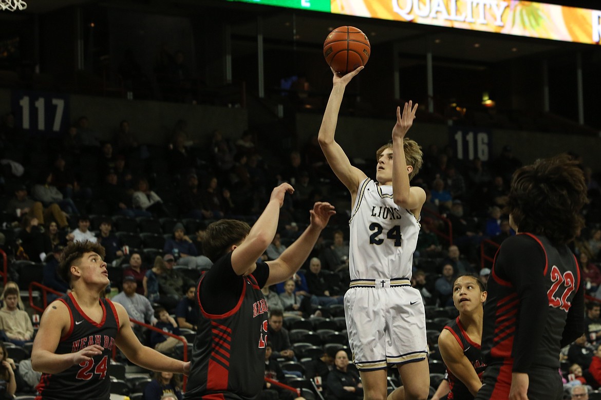 MLCA/CCS sophomore Johnny Ferguson, in white, shoots the ball in the second quarter against Neah Bay.