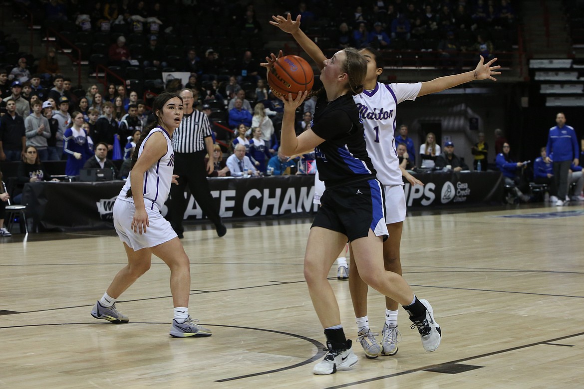 Warden senior Molly Sackmann, in black, attempts a shot in the first quarter against Mabton.