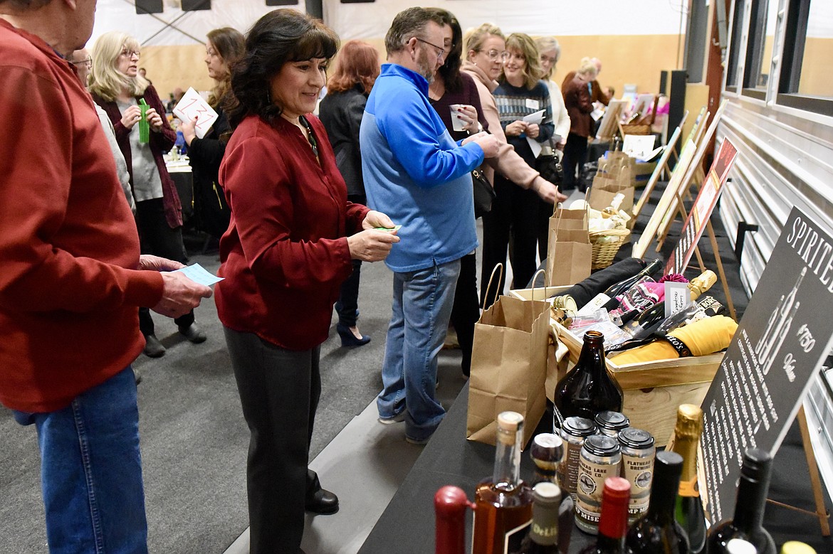 Guests browse raffle items at the Bigfork Chamber of Commerce banquet and awards ceremony in Bigfork on Thursday, Feb. 22, 2024. (Matt Baldwin/Daily Inter Lake)