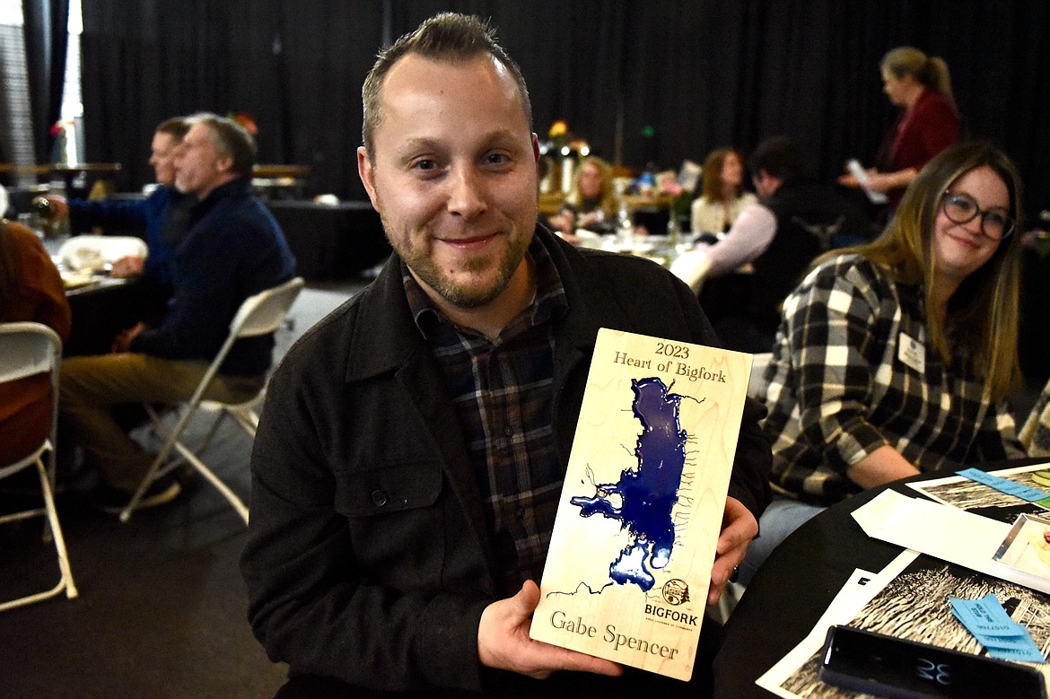 Gabe Spencer from Whistling Andy distillery in Bigfork holds his award at the Bigfork Chamber of Commerce banquet and awards ceremony on Thursday, Feb. 22, 2024. (Matt Baldwin/Daily Inter Lake)