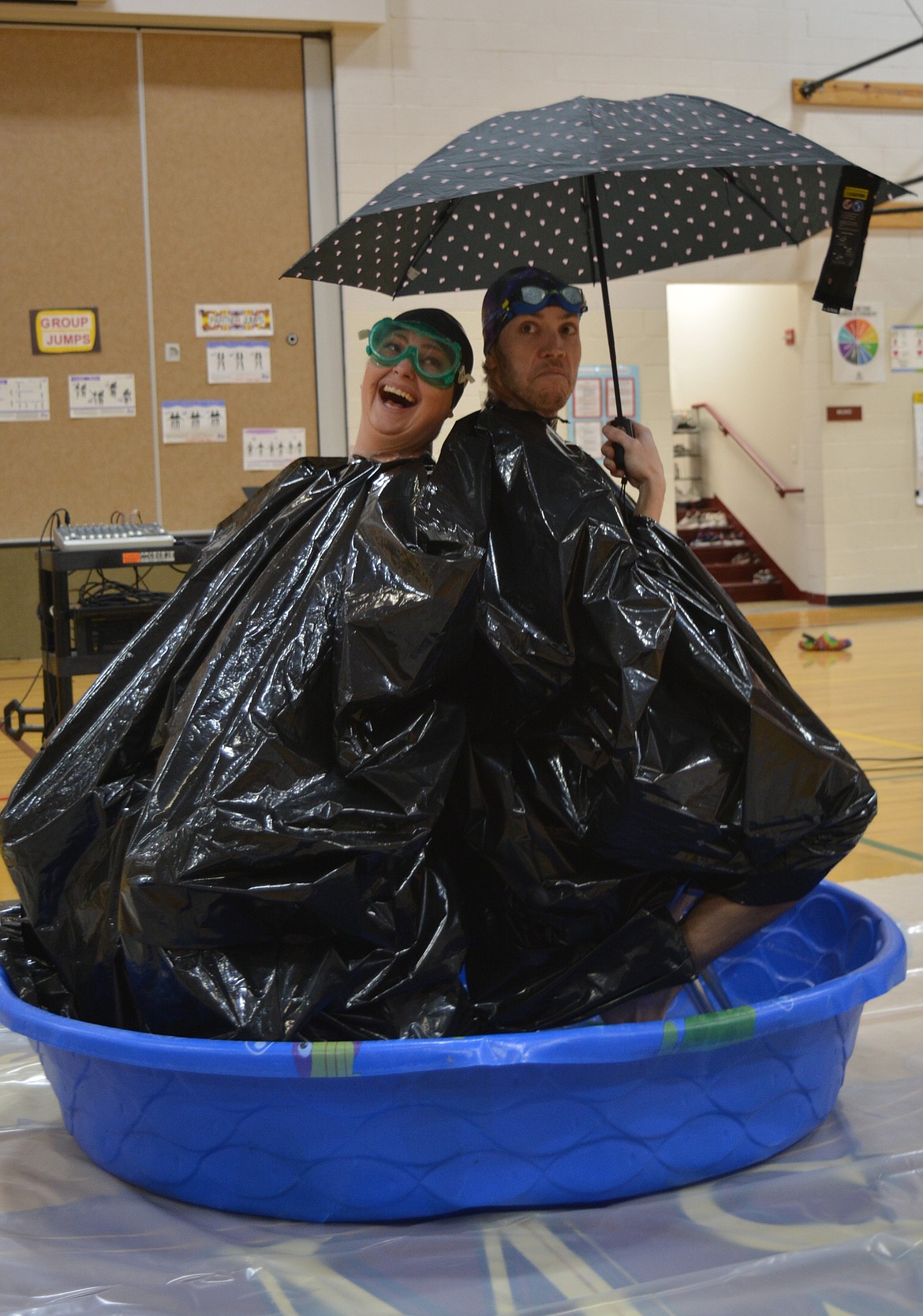 Steven Blee earns a laugh and playful cries of "boo" from the student assembly  Friday as he pretends to enact a plan to deflect the slime from him and Principal Crystal Silvers.