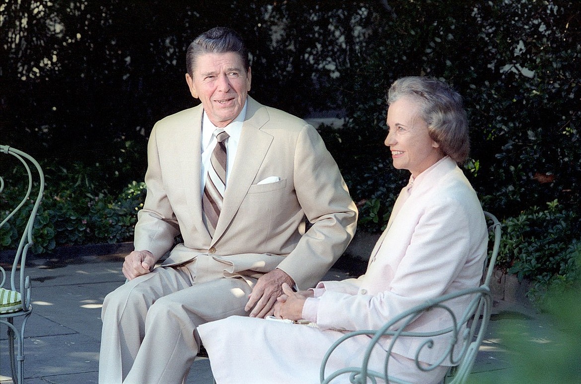 Then Supreme Court nominee Sandara Day O’Connor visits with former President Ronald Reagan outside the White House on July 15, 1981. Reagan nominated O’Connor to replace Justice Potter Stewart upon Stewart’s retirement.