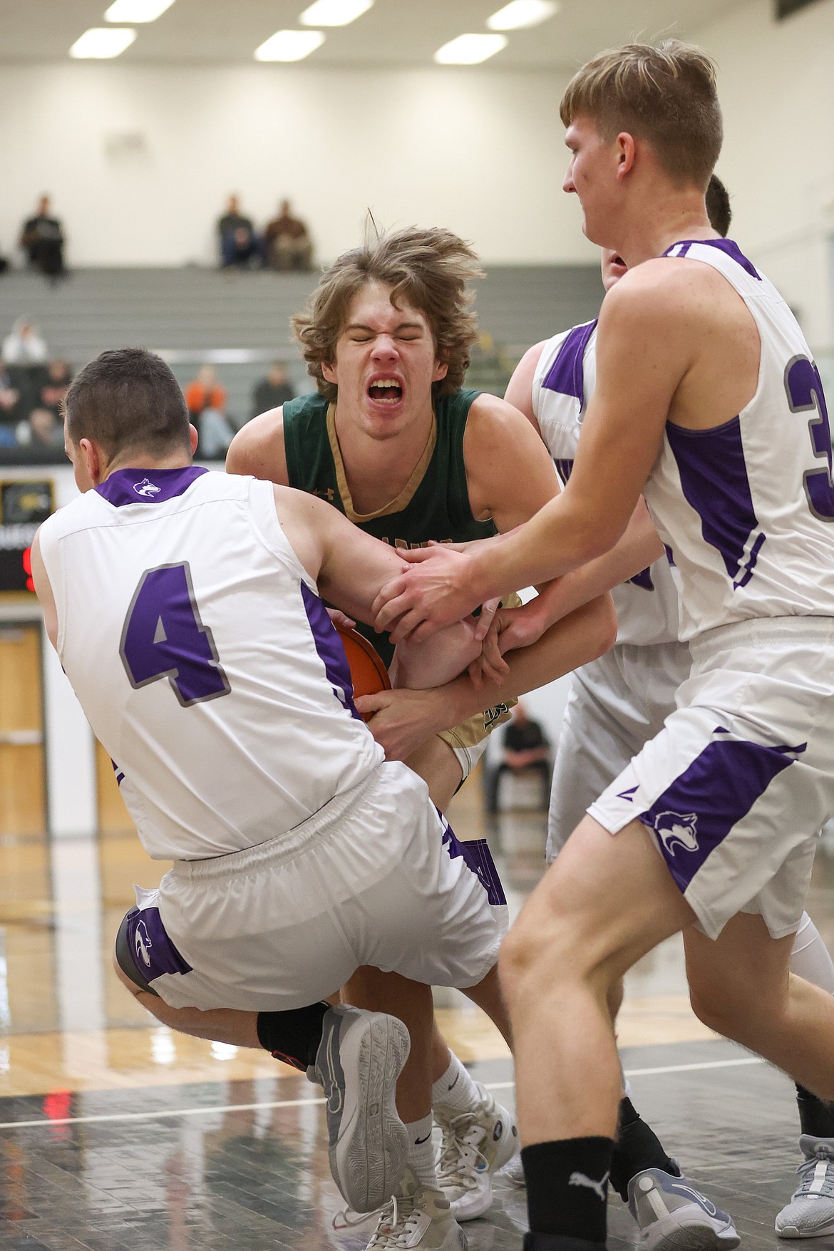 JASON DUCHOW PHOTOGRAPHY
St. Maries senior Wyatt Holmes gets tied up by North Fremont defenders during Friday's state 2A boys basketball loser-out game at Capital High in Boise.