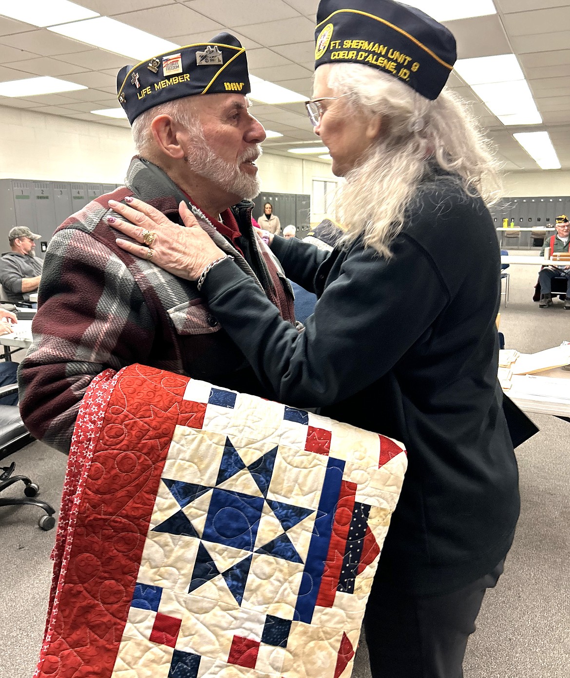 Ray Almeida and wife Janet Almeida share a moment after he received a Quilt of Valor on Tuesday.