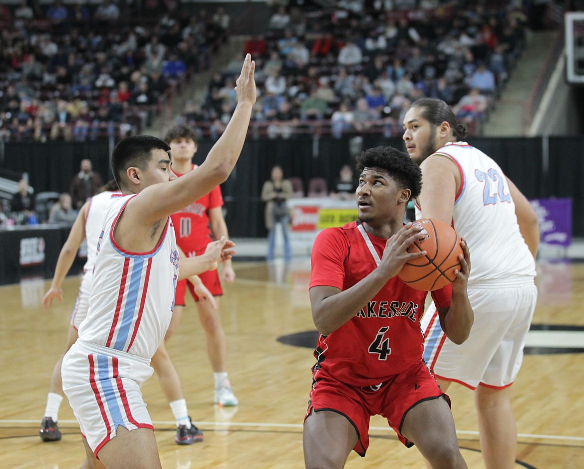 MARK NELKE/Press
Lakeside senior Blaze Callahan (4) looks for his shot as Quenten Kipp (10) and Christopher Bohnee (22) of Lapwai defend on Saturday during the state 1A Division 1 championship game at the Ford Idaho Center in Nampa.