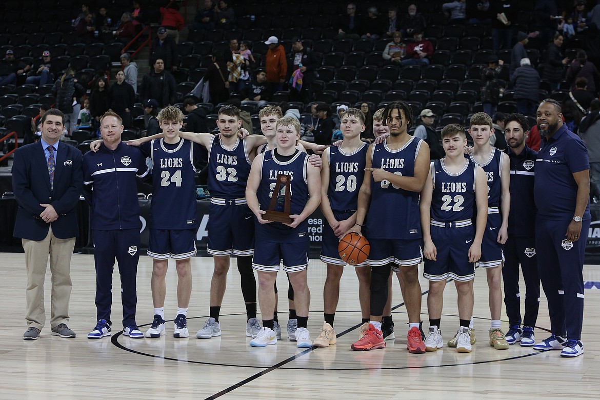 Warden players celebrate after placing third in the 2B Girls State Basketball Tournament Saturday at the Spokane Arena. The No. 2 seed Cougars defeated No. 6 Adna 74-68 in the third/fifth-place game.