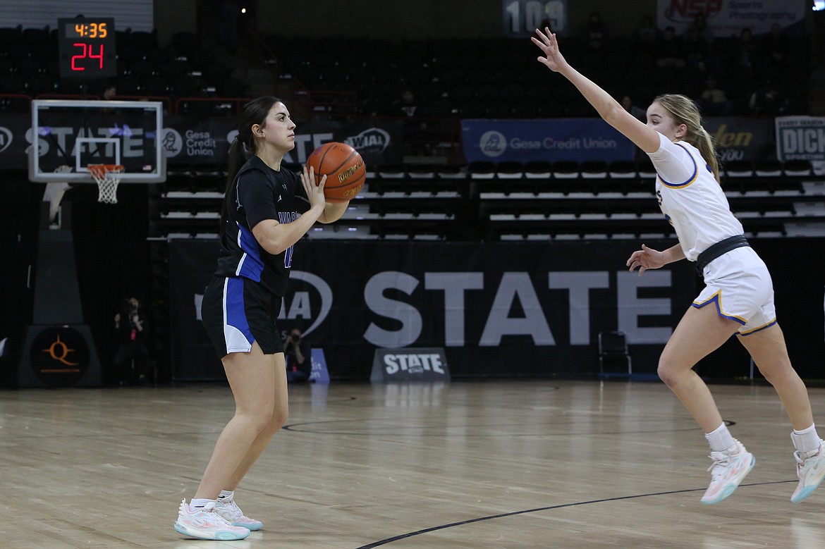 Warden senior Aliza Leinweber, left, attempts a three-pointer in the second quarter against Adna.