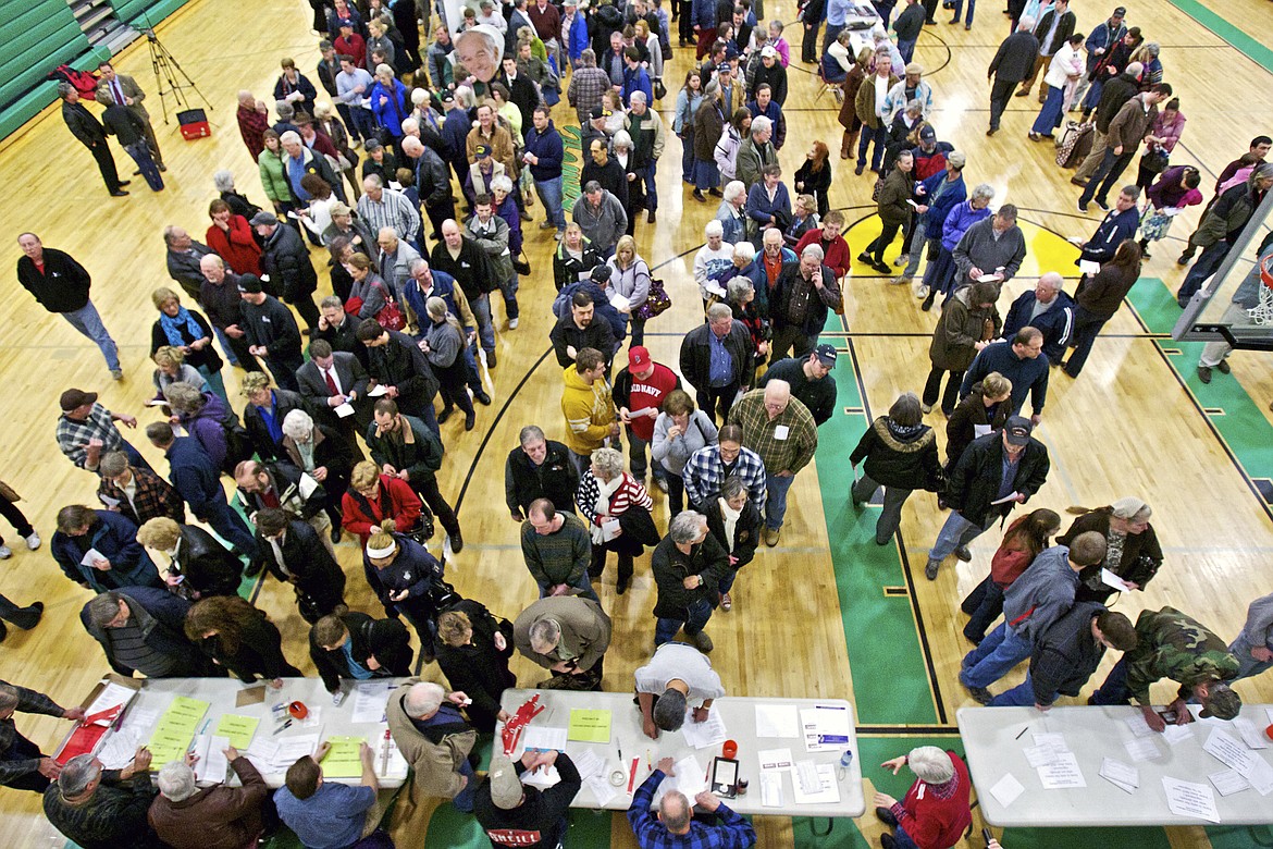 Registered Republican voters stand in line March 6, 2012, for the caucus event in Rathdrum, Idaho. Idaho Republicans will gather in presidential caucuses this Saturday, March 2, 2024, to help pick their party's presidential standard-bearer. Former president Donald Trump and former United UN Nikki Haley will compete for the state's 32 Republican delegates, as will Texas businessman and pastor Ryan Binkley. (AP Photo/Coeur d'Alene Press, Jerome A. Pollos)